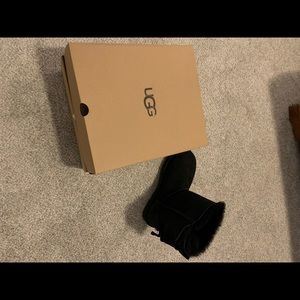 Short black Uggs with bows up the back.